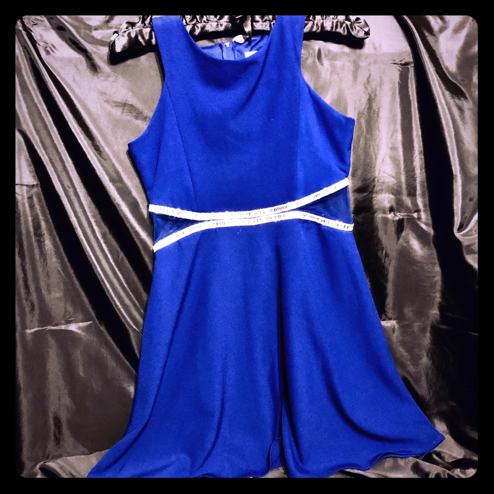 Girl's dress with rhinestones and sheer inserts.